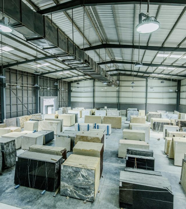 shiva & kk Marbles Expansive warehouse filled with large stone slabs